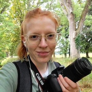 Photo of the artist holding a camera